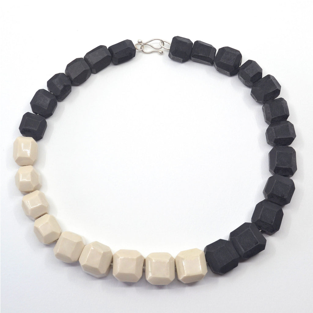 Unique black and white porcelain choker necklace. The beads are handmade and hand-faceted of porcelain. The clasp is handcrafted of fine silver.