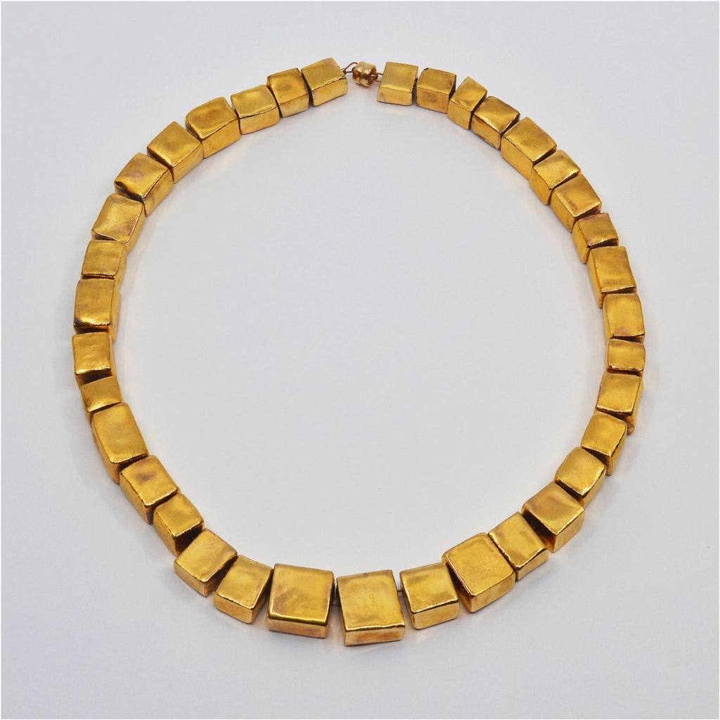 Unique 22 karat gold luster glazed porcelain choker necklace. Each cube-shaped bead is handmade. 14 karat gold-filled magnetic clasp.