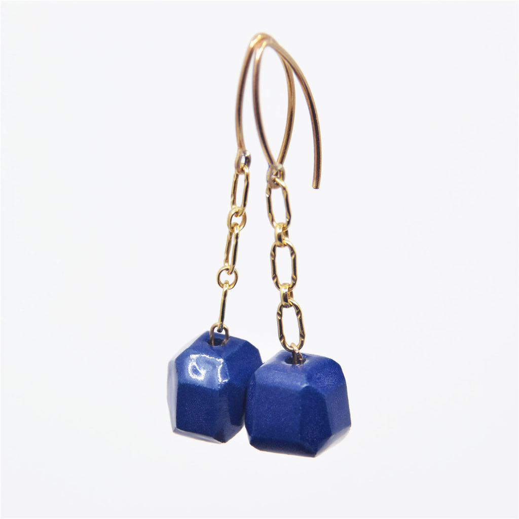 One-of-a-kind gem cut blue porcelain bead earrings on 14 karat gold-filled chain dangle. Overall length 1 1/4", faceted blue porcelain bead 3/8" x 3/8" x 3/8".   14 karat gold-filled ear wire. 