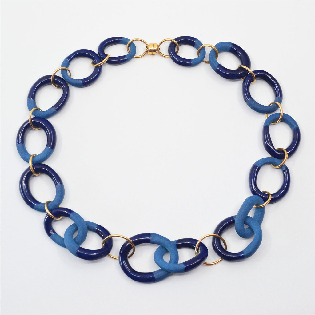 Unique blue porcelain choker necklace glazed navy blue, partially unglazed chain elements with 14 karat gold-filled rings and magnetic clasp.