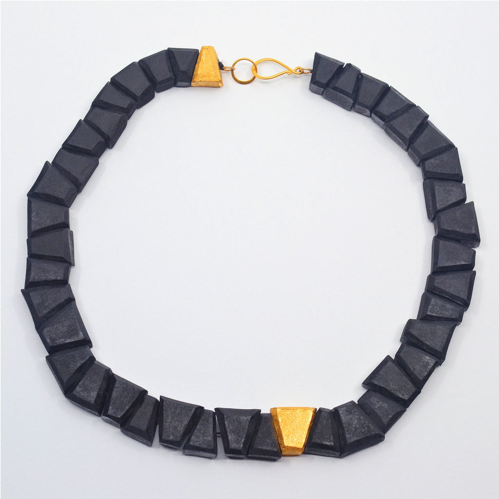 Unique handcrafted porcelain choker necklace. Each bead is hand-faceted and individually glazed, in matte black and matte 22 karat gold glaze, with a golden hook clasp.