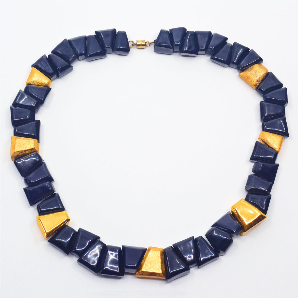 Unique dark blue hand-faceted porcelain beads choker necklace. Glazed in dark shiny blue and 22 karat gold in both matte and glossy, with a 14 karat gold-filled magnetic clasp.